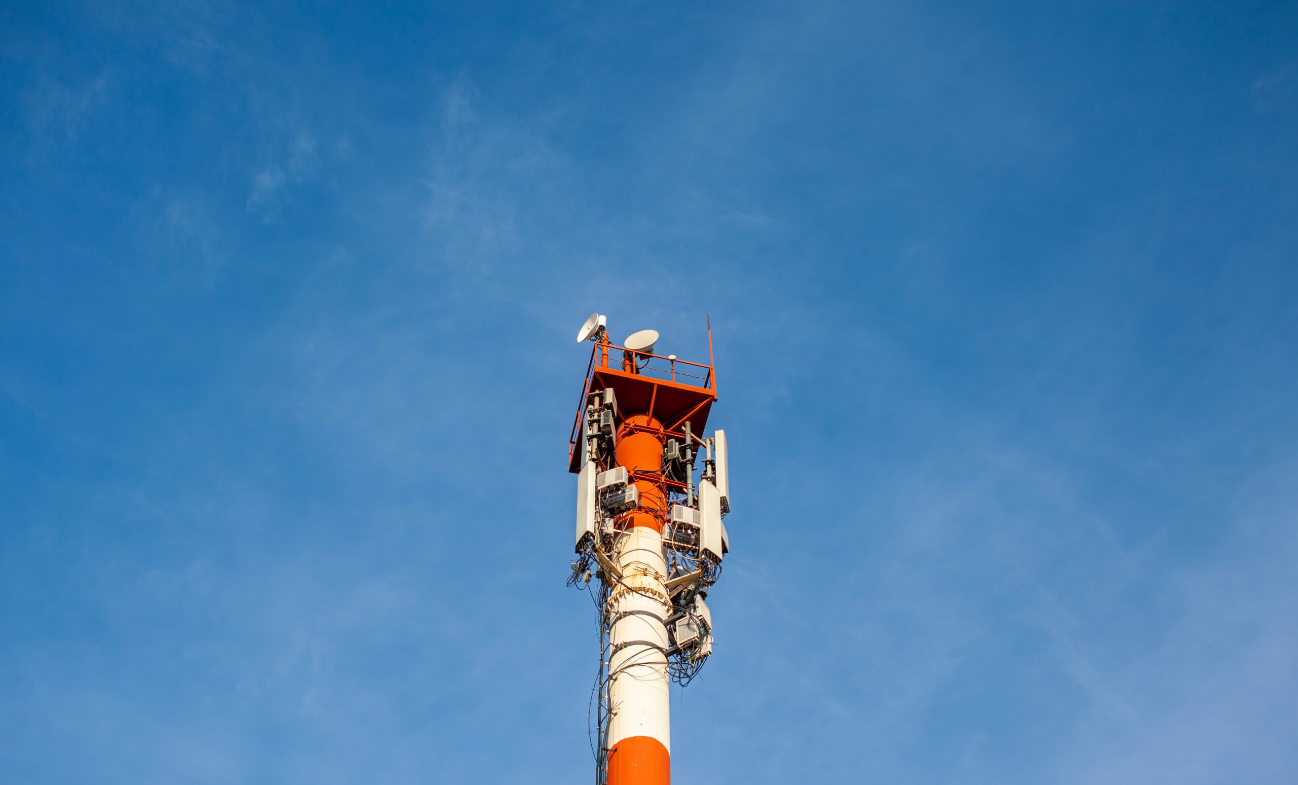 Technology on the top of the telecommunication GSM 5G,4G,3G tower.Cellular phone antennas on a building roof.Telecommunication mast television antennas.Receiving and transmitting stations